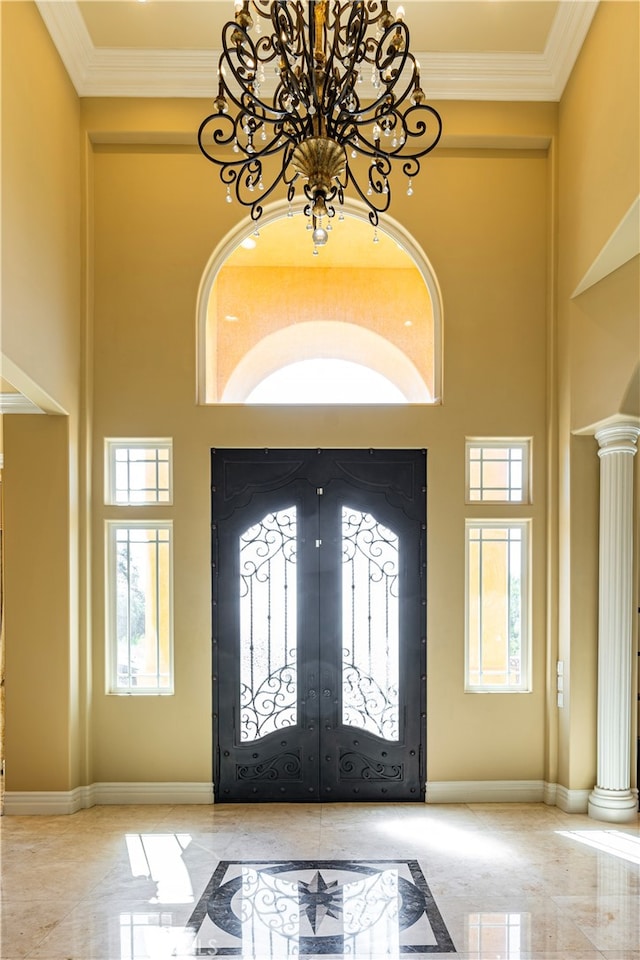 805 W Road Ln, Habra Heights, CA 90631 - entryway featuring a chandelier, inlaid floor details, a towering ceiling, marble tiled floors, and decorative columns