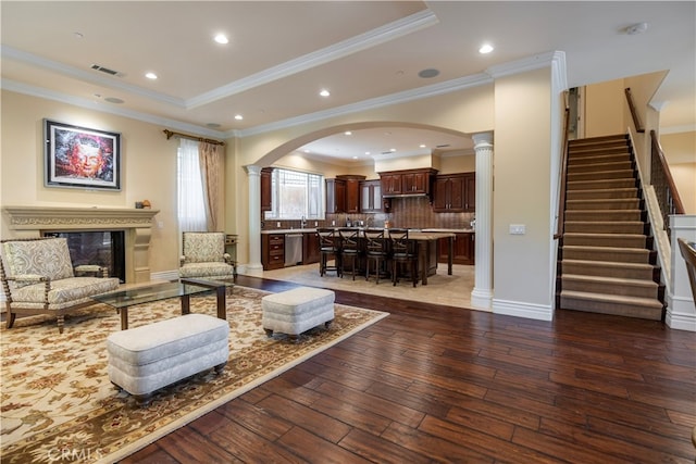 805 W Road Ln, Habra Heights, CA 90631 - living room featuring decorative columns, arched walkways, wood-type flooring, stairs, and ornamental molding