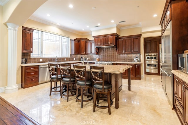 805 W Road Ln, Habra Heights, CA 90631 - kitchen featuring stainless steel appliances, a warming drawer, an island with sink, a kitchen bar, and ornamental molding