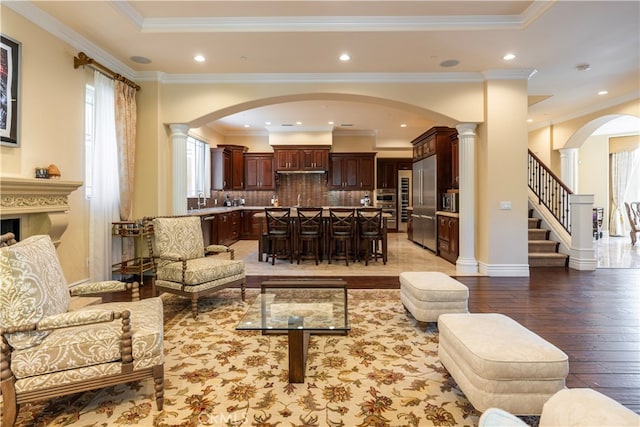 805 W Road Ln, Habra Heights, CA 90631 - living area with light wood finished floors, ornate columns, arched walkways, recessed lighting, and baseboards