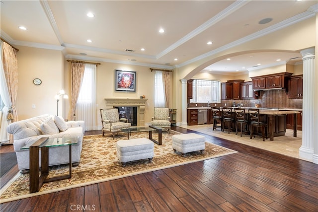805 W Road Ln, Habra Heights, CA 90631 - living area featuring ornate columns, healthy amount of natural light, arched walkways, hardwood / wood-style floors, and crown molding