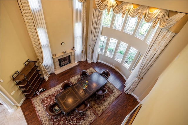805 W Road Ln, Habra Heights, CA 90631 - living area with a fireplace, wood-type flooring, baseboards, and a high ceiling