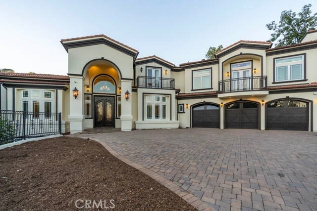 805 W Road Ln, Habra Heights, CA 90631 - mediterranean / spanish house with french doors, a balcony, a garage, and decorative driveway