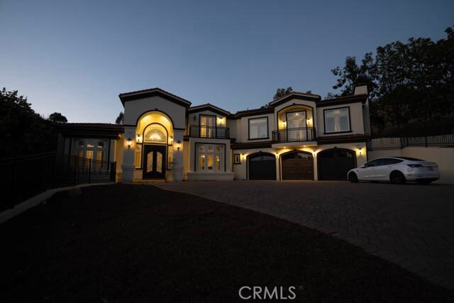 805 W Road Ln, Habra Heights, CA 90631 - mediterranean / spanish house with a balcony, driveway, a garage, french doors, and a chimney