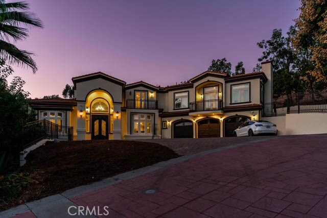 805 W Road Ln, Habra Heights, CA 90631 - mediterranean / spanish-style home with french doors, a balcony, a garage, a chimney, and driveway
