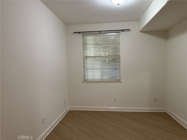 empty room with hardwood / wood-style flooring