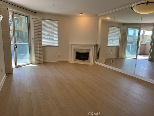 unfurnished living room with light wood-type flooring and a healthy amount of sunlight