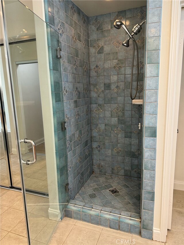 bathroom featuring walk in shower and tile patterned flooring