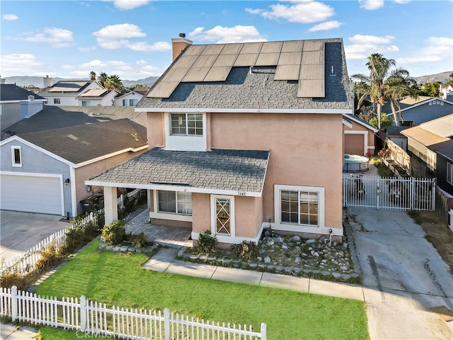 view of front of property with a garage and a front lawn