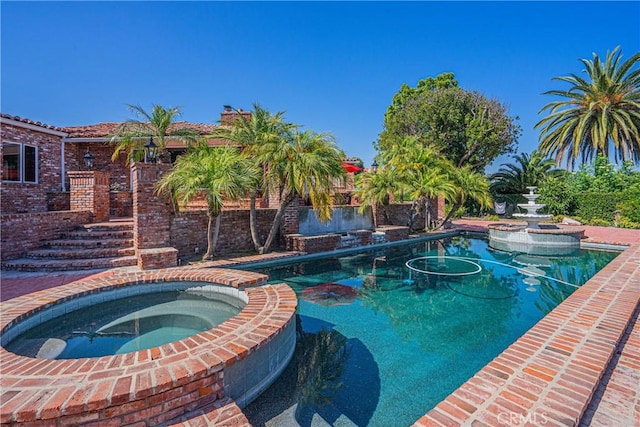 view of pool featuring an in ground hot tub