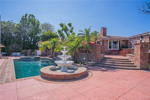 view of pool featuring an in ground hot tub