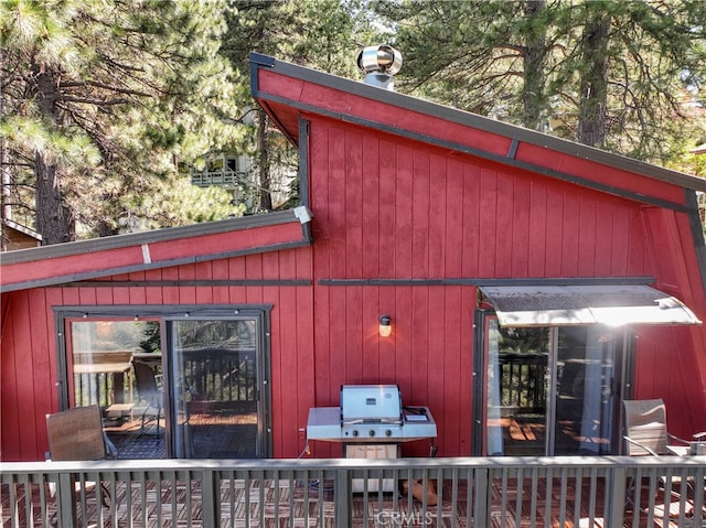 view of home's exterior with a wooden deck