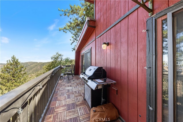 balcony featuring a mountain view and grilling area