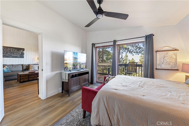 bedroom featuring ceiling fan, light wood-type flooring, vaulted ceiling, and access to outside