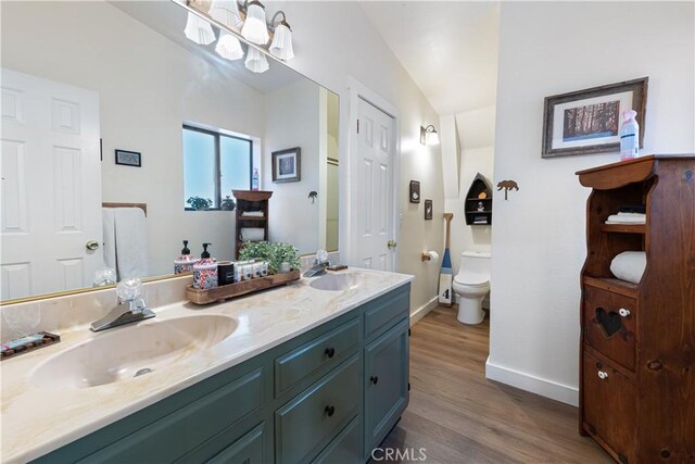 30897 Glen Oak Dr, Running Springs, CA 92382 - full bath featuring double vanity, wood finished floors, baseboards, and toilet