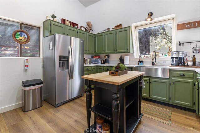 30897 Glen Oak Dr, Running Springs, CA 92382 - kitchen featuring stainless steel fridge with ice dispenser, green cabinetry, a sink, butcher block counters, and light wood-style floors