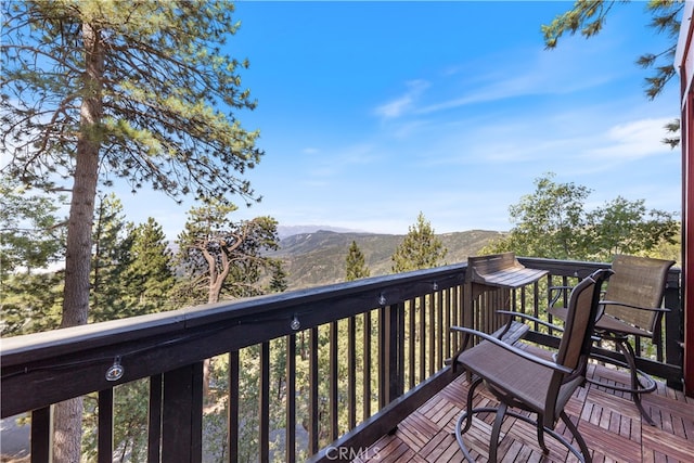 wooden deck featuring a mountain view