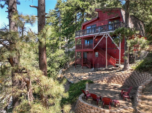 30897 Glen Oak Dr, Running Springs, CA 92382 - rear view of property with an outdoor fire pit, stairs, and a deck