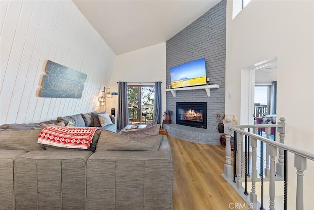 30897 Glen Oak Dr, Running Springs, CA 92382 - living room featuring a high ceiling, wood finished floors, a fireplace, and wooden walls