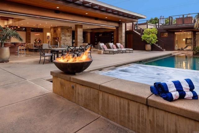 view of swimming pool with a hot tub and a patio area