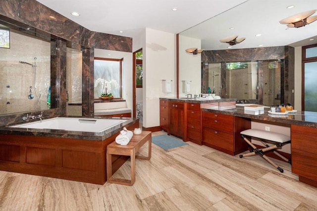 bathroom featuring vanity and shower with separate bathtub