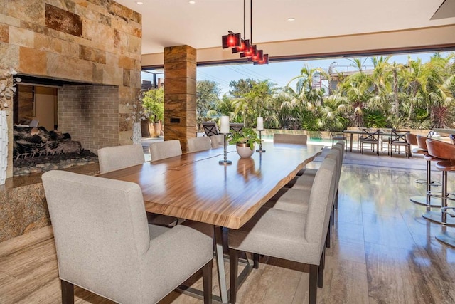 dining room with light hardwood / wood-style flooring and a healthy amount of sunlight