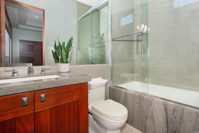 full bathroom with vanity, combined bath / shower with glass door, and toilet