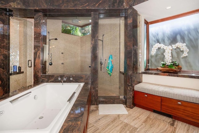 bathroom featuring separate shower and tub