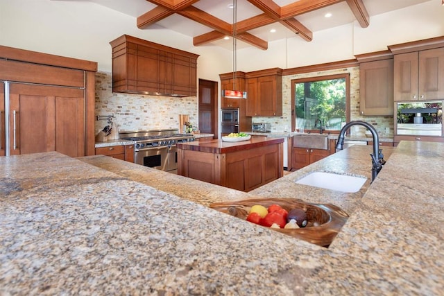 kitchen featuring decorative backsplash, beam ceiling, stainless steel appliances, sink, and premium range hood