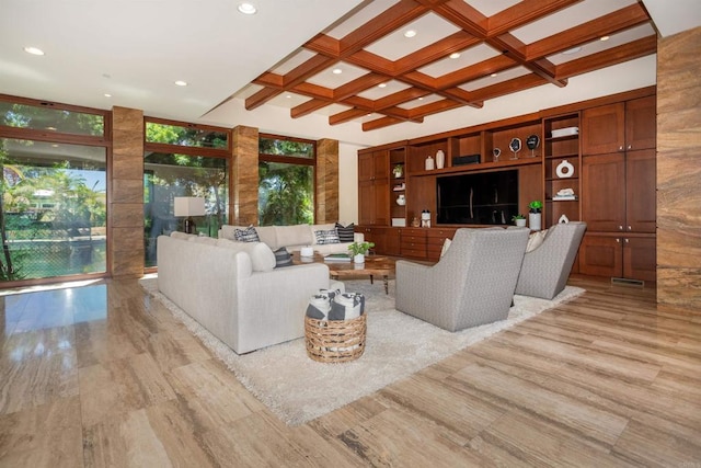 living room with coffered ceiling, light wood-type flooring, and a wealth of natural light