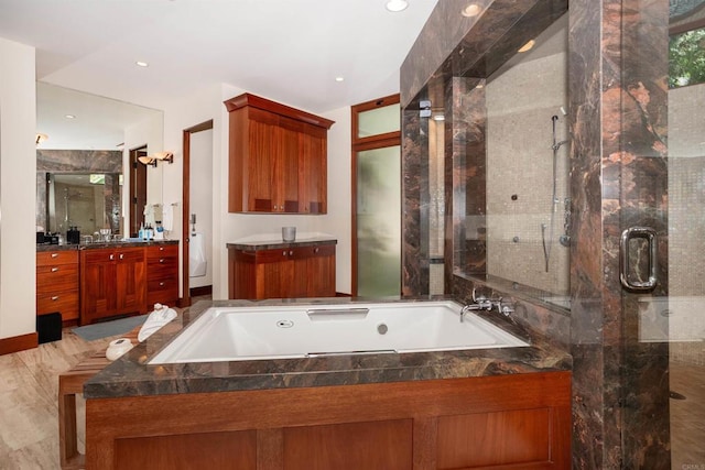 full bathroom with toilet, hardwood / wood-style floors, vanity, and separate shower and tub