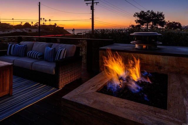 deck at dusk with outdoor lounge area