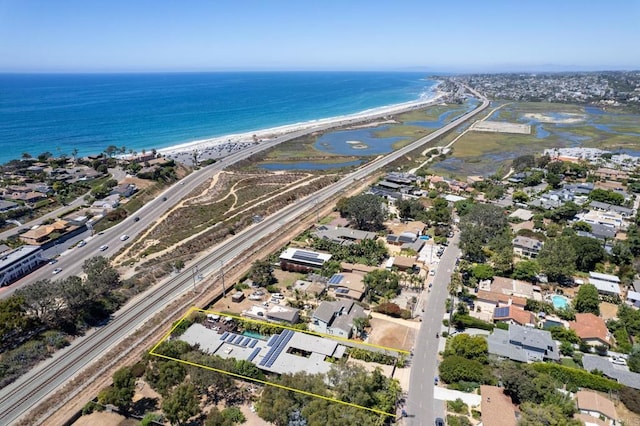 drone / aerial view featuring a water view and a beach view