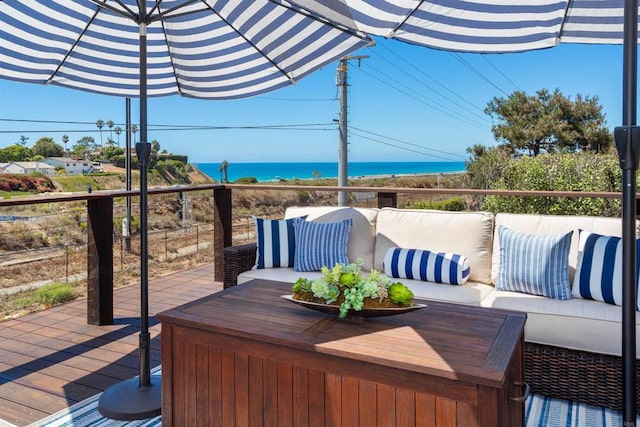 wooden terrace with outdoor lounge area and a water view