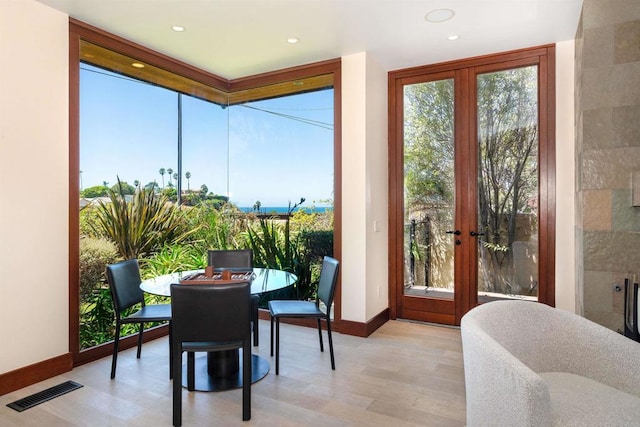 sunroom / solarium featuring french doors