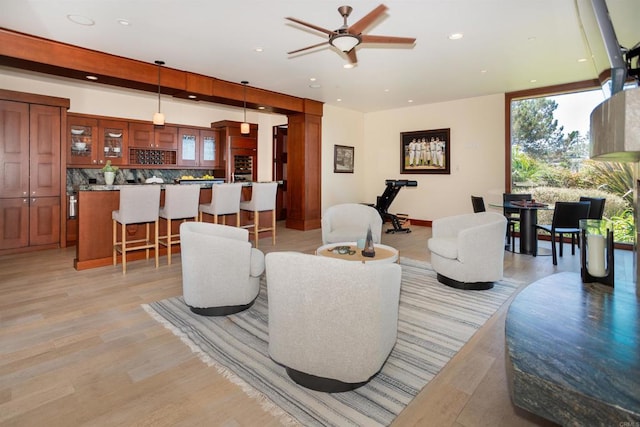 living room featuring light hardwood / wood-style flooring and ceiling fan