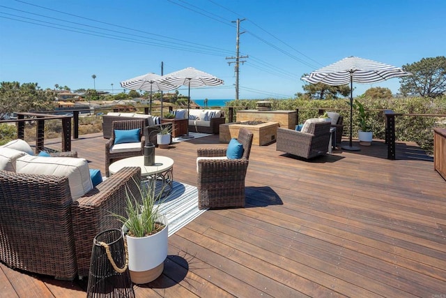 wooden deck with a water view and an outdoor hangout area