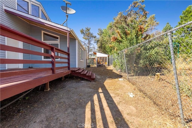 view of yard with fence and a deck