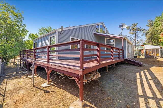 rear view of property with a wooden deck