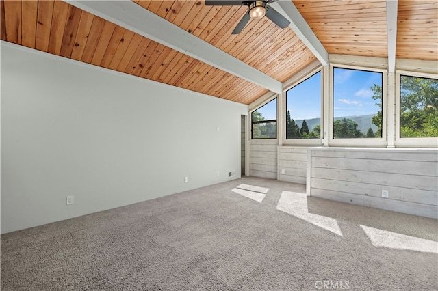 additional living space with wood ceiling, carpet flooring, lofted ceiling with beams, and wood walls