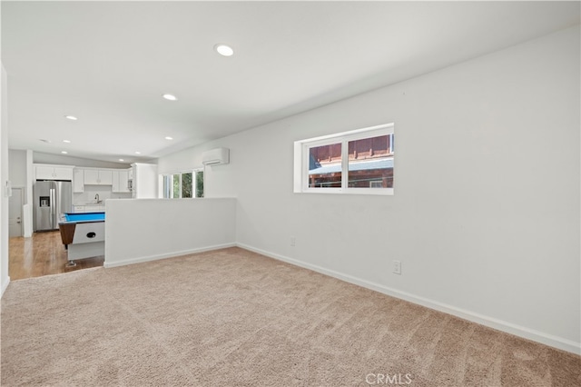 interior space with an AC wall unit and light carpet