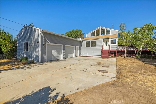 view of front of home featuring a deck and a garage