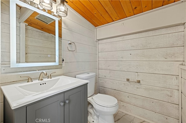 bathroom featuring vanity, toilet, wood walls, wooden ceiling, and vaulted ceiling