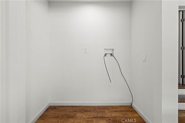 laundry room with dark hardwood / wood-style floors and washer hookup