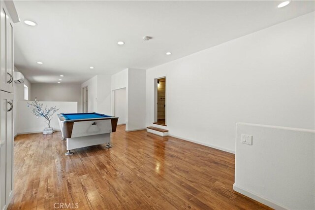 playroom with pool table, wood-type flooring, and a wall unit AC