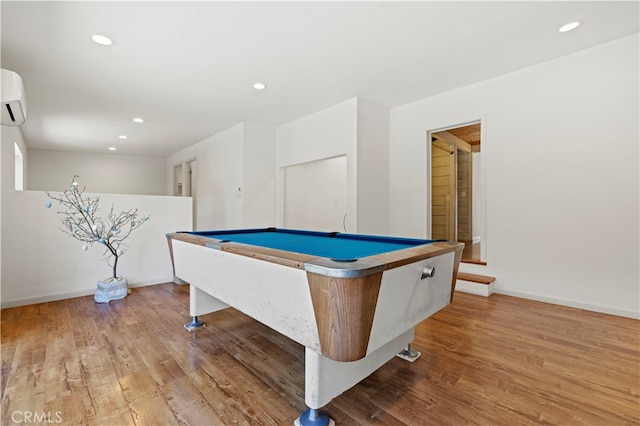 playroom with wood-type flooring, billiards, and a wall mounted AC