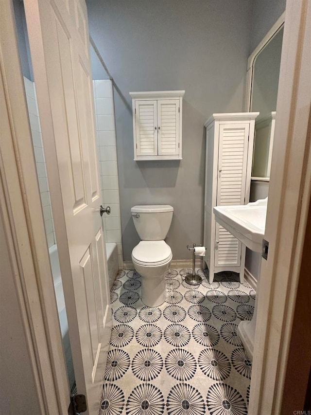 bathroom with toilet, shower / bath combination, and tile patterned floors