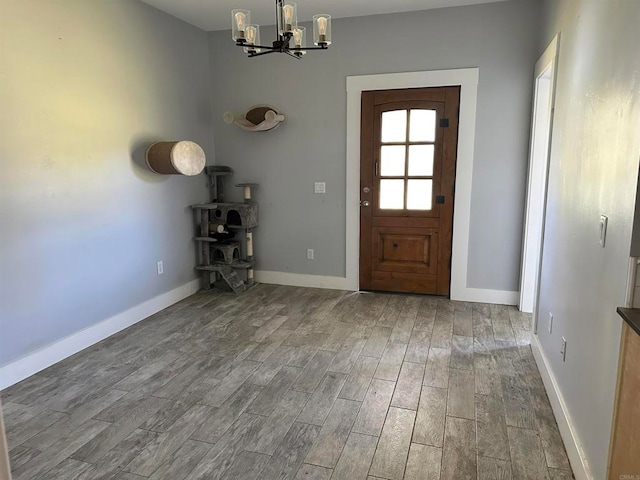 entrance foyer with hardwood / wood-style floors and a chandelier