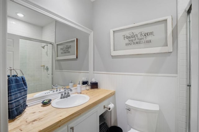 bathroom featuring vanity, toilet, and a shower with shower door