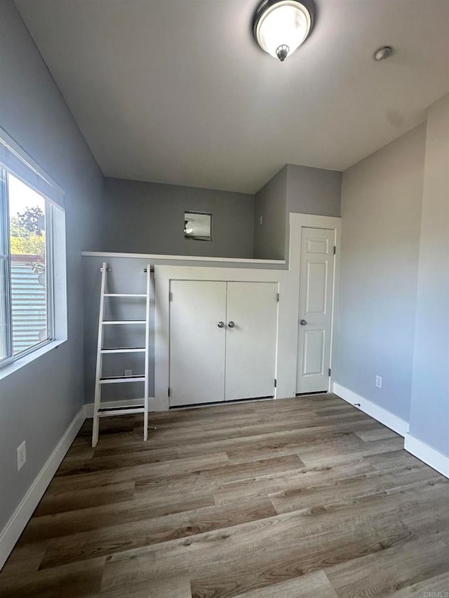 unfurnished bedroom with wood-type flooring